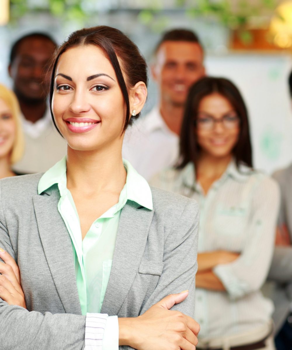 Cheerful group of co-workers standing in office